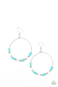 Dainty silver beads, refreshing turquoise, and earthy white stone beads slide along a dainty silver hoop for a seasonal look. Earring attaches to a standard fishhook fitti