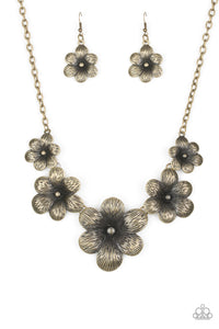 <p>Brushed in an antiqued shimmer, lifelike brass flowers gradually increase in size as they link below the collar in a seasonal fashion. Features an adjustable clasp closure.</p> <p>&nbsp;</p>