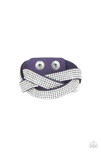 Encrusted in row after row of glittery white rhinestones, three blue suede bands braid across the wrist for a sassy look. Features an adjustable snap closure.