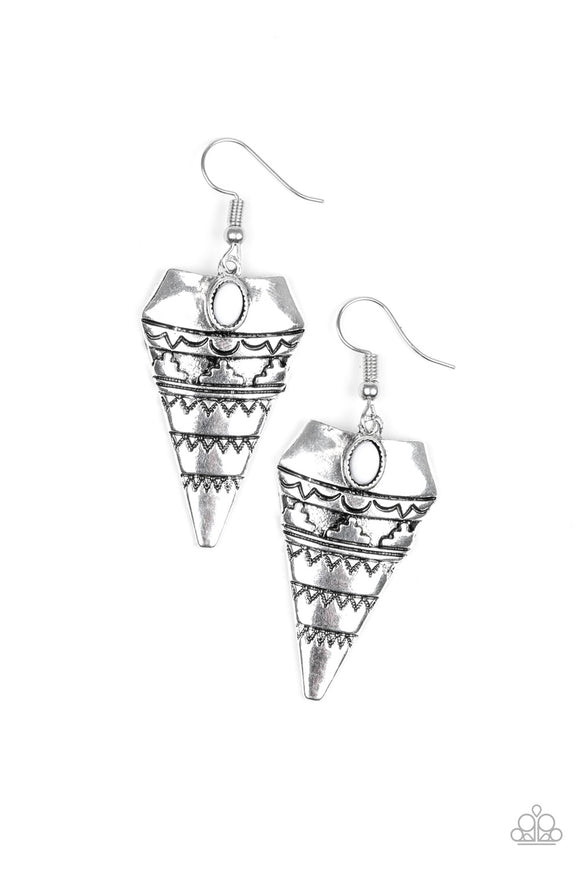 Stamped and embossed in tribal inspired patterns, an antiqued triangular frame swings from the ear. A dainty white bead is pressed into the top of the frame for a refreshing splash of color. Earring attaches to a standard fishhook fitting.  Sold as one pair of earrin