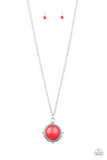 A fiery red stone is pressed into a shimmery silver frame radiating with metallic rope-like texture, creating a bold pendant at the bottom of a lengthened silver chain. Features an adjustable clasp closure.