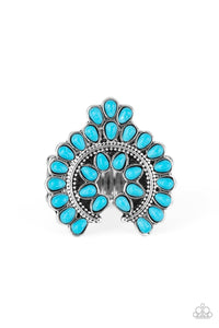 Dainty turquoise teardrop stones are pressed into a studded silver frame, creating a whimsical squash blossom centerpiece atop the finger. Features a stretchy band for a flexible fit.