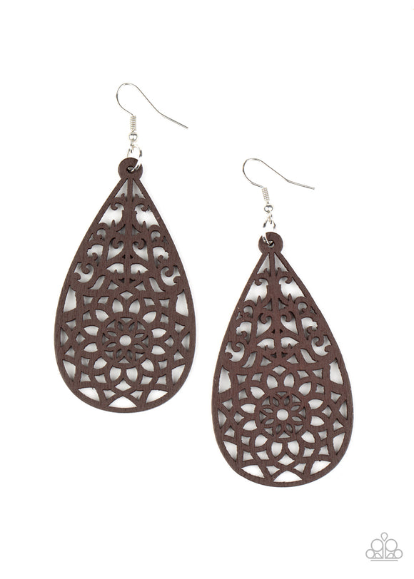 A brown wooden teardrop is cut into a stenciled floral pattern, creating a whimsical lure. Earring attaches to a standard fishhook fitting.