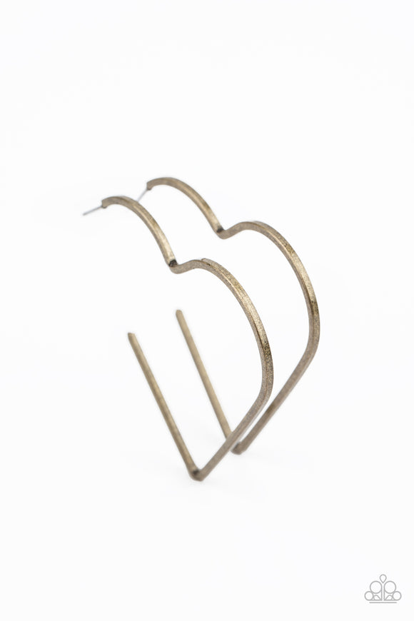 Brushed in a rustic antiqued finish, a flat brass bar delicately bends into an airy heart frame for a flirtatious finish. Earring attaches to a standard post fitting. Hoop measures approximately 2