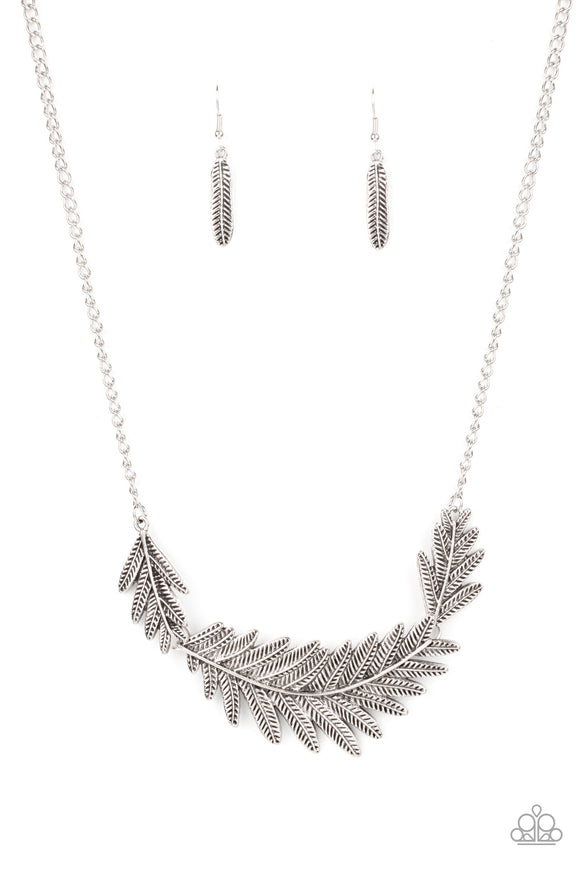 Etched and embossed in lifelike textures, leafy silver plates connect into a dramatic feather below the collar for a seasonal statement. Features an adjustable clasp closure.