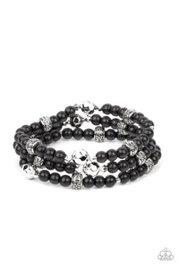 A dainty collection of faceted silver beads, floral embossed accents, and polished black beads are threaded along stretchy bands around the wrist for a colorfully seasonal look.  Sold as one set of three bracelets.