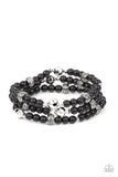 A dainty collection of faceted silver beads, floral embossed accents, and polished black beads are threaded along stretchy bands around the wrist for a colorfully seasonal look.  Sold as one set of three bracelets.