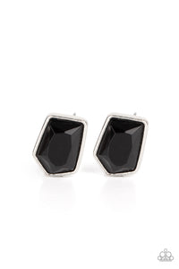 Featuring a raw asymmetrical cut, a glittery black gem is encased inside a sleek silver frame, creating an edgy display. Earring attaches to a standard post fitting.