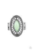 A silver frame embellished with dewy white beads and studded silver texture creates a stunning backdrop for a Green Ash marquise cut bead as it sits atop the finger. Features a stretchy band for a flexible fit.