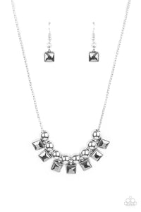 Smoky hematite square rhinestone frames and oversized silver beads alternate along a silver popcorn chain, creating a stellar fringe below the collar. Features an adjustable clasp closure.