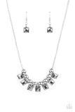 Smoky hematite square rhinestone frames and oversized silver beads alternate along a silver popcorn chain, creating a stellar fringe below the collar. Features an adjustable clasp closure.