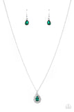 A glittery green teardrop gem is pressed into the center of a pronged border of glassy white rhinestones that sits atop a ring of a silver frame dotted in pairs of white rhinestones. The glittery pendant swings from the bottom dainty silver chain, creating a vintage inspired pendant below the collar. Features an adjustable clasp clo