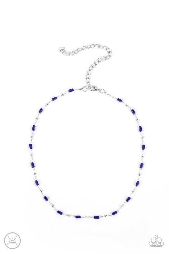 Dainty silver beads and cylindrical blue beads delicately link around the neck, creating a minimalist inspired pop of color. Features an adjustable clasp closure.