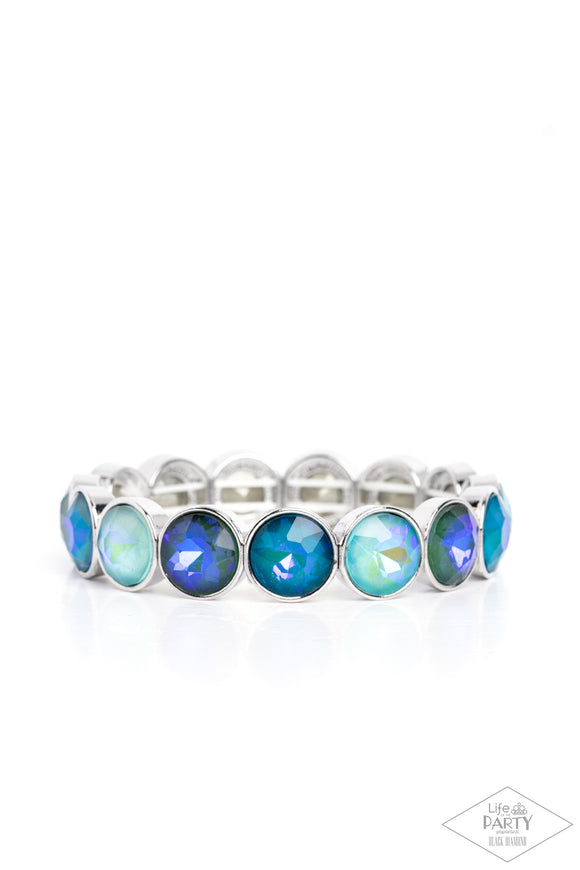 Encased in sleek silver fittings, a sparkly series of opalescent green and blue rhinestones are threaded along stretchy bands around the wrist for a radiant finish.