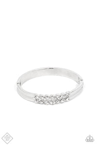 Stacked layers of brilliant white rhinestones give way to double layers of sleek silver frames that feature a subtle wave, creating a dramatically modern design around the wrist. Features a hinged closure.