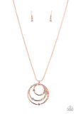 Sporadically encrusted in glittery white rhinestones, shiny copper rings coalesce into a spellbinding pendant at the bottom of a round shiny copper snake chain for a glamorous look. Features an adjustable clasp closure.