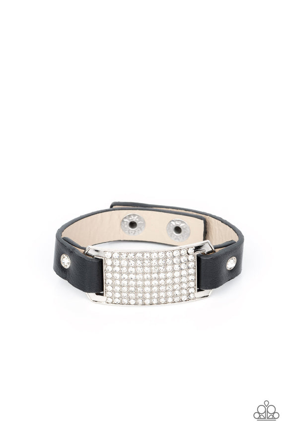 Black leather bands are looped through the ends of a white rhinestone embellished silver frame and studded in place with glitzy white rhinestone studs, creating a glamorous centerpiece around the wrist. Features an adjustable snap closure.