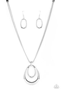 Two shiny silver oval frames delicately coalesce into a glistening pendant at the bottom of layered rows of silver box chain, creating a classic metallic look below the collar. Features an adjustable clasp closur