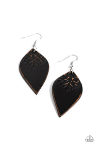 The top of a petal shaped black leather frame is stamped in a distressed floral pattern, resulting in a rustic display. Earring attaches to a standard fishhook fitting.  Sold as one pair of earrings