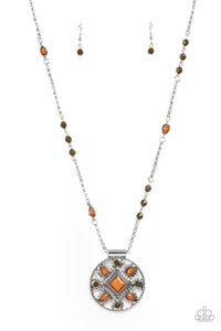 A square brown bead is pressed into the silver studded center of a textured silver hoop radiating with round Olive Branch and teardrop brown beads. The decorative medallion swings from the bottom of a beaded silver chain, creating a colorful tribal inspired display. Features an adjustable clasp cl