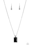 Featuring a white rhinestone encrusted silver fitting, an oversized emerald cut black rhinestone swings from the bottom of a dainty silver chain below the collar for a glamorous fashion. Features an adjustable clas