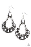 Dotted with white beads and dainty white rhinestones, a filigree filled silver wreath swings from the bottom of a matching white bead for a whimsical fashion. Earring attaches to a standard fishhook fitting.