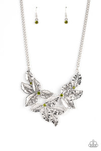 A textured collection of silver holly-like leaves are dotted with dainty green rhinestones as they bloom below the collar, invoking a festive spirit. Features an adjustable clasp closure.