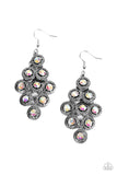 Dotted with iridescent rhinestone centers, tiers of textured silver frames cascade from a metallic backdrop for a stellar tasseled look. Earring attaches to a standard fishhook fitting.