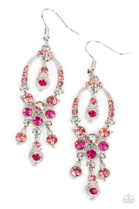 A pink rhinestone encrusted silver horseshoe frame delicately attaches to a glitzy tassel of pink, Fuchsia Fedora, and iridescent rhinestones for a timeless twinkle. A matching pink and Fuchsia Fedora rhinestone embellished frame daintily swings from the top of the glamorous frame, complimenting the effervescent movement. Earring attaches to a standard fishhook fitting.