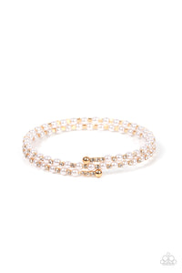 Dainty white pearls and white rhinestone dotted gold fittings alternate along an infinity wire around the wrist, resulting in wraparound shimmer