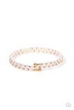 Dainty white pearls and white rhinestone dotted gold fittings alternate along an infinity wire around the wrist, resulting in wraparound shimmer