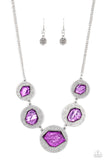 Featuring a refracted shimmer, asymmetrical, glassy purple gems sparkle atop textured silver discs as they delicately link into an edgy statement piece below the collar. Features an adjustable clasp closure.