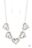 Bordered in glassy white rhinestones, an oversized collection of beveled silver heart frames delicately links below the collar for a dramatically romantic look. Features an adjustable clasp closure.