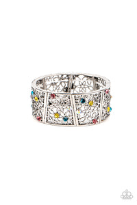 Sporadically dotted with multicolored and iridescent rhinestones, an airy daisy pattern blooms inside trapezoidal silver frames that are threaded along stretchy bands around the wrist for a seasonal statement. Due to its prismatic palette, color may v