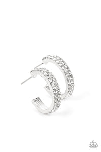 Sparkling white rhinestones line the front of a petite silver hoop, creating edge to edge shimmer. Earring attaches to a standard post fitting. Hoop measures approximately 3/4" in diameter.