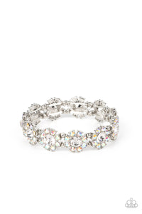 Separated by pairs of dainty silver beads, iridescent rhinestone dotted petals bloom from oversized white rhinestone centers along stretchy bands around the wrist for a flirtatious floral fashion. Due to its prismatic palette, color may vary.