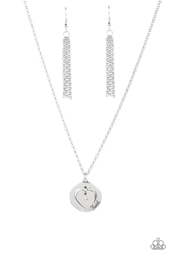 Dotted with a dainty white rhinestone, a silver heart charm swings freely inside of a heart-cutout silver frame. Stamped in the word, 