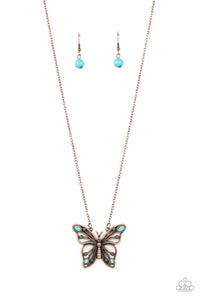 Accented in oval turquoise stones, a decorative copper butterfly flutters at the bottom of a copper chain for a free-spirited finish. Features an adjustable clasp closure.