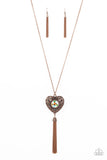 A magical iridescent peach gem sparkles at the center of a 3-dimensional copper heart. Filled with vine-like filigree, the locket-inspired heart pendant glides along an extended copper chain while a shimmery tassel of copper chain dances from the bottom for a flirtatious finish. Features an adjustable clasp closure. Due to its prismatic palette, color may vary.