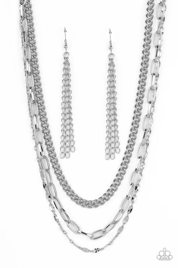 Three different kinds of weighted silver chains layer down the neck to create a gritty, edgy statement piece. Features an adjustable clasp.