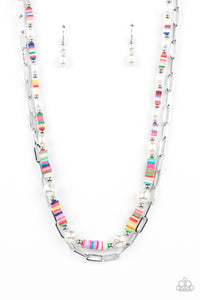 Sections of colorful rubber discs in rainbow shades are separated by tiny silver beads and a variety of white baroque pearls to create an unexpected mashup of texture along the collar. A strand of silver paperclip link chain is paired with the abstract design in a layered finish. Features an adjustable clasp closure.