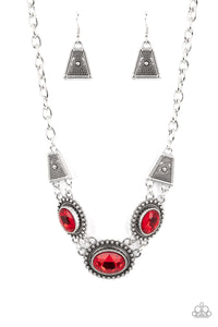 Classic oval-shaped rhinestones in a vibrant red hue sit prominently atop silver frames bordered in studded texture. Trapezoidal shaped frames filled with dizzying silver texture lay on each side of the colorful gems, as they fall along the collar in a breathtaking finish. Features an adjustable clasp closure.