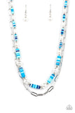 Sections of colorful rubber discs in shades of blue, turquoise, and navy are separated by tiny silver beads and a variety of white baroque pearls to create an unexpected mashup of texture along the collar. A strand of silver paperclip link chain is paired with the abstract design in a layered finish. Features an adjustable clasp closure.