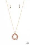 Brilliant emerald cut rhinestones brushed in an iridescent shimmer are pressed inside a wide circular gold frame, creating a glitzy pendant at the bottom of a dainty gold chain. Features an adjustable clasp closure. Due to its prismatic palette, color may vary.