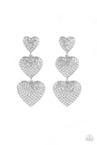 Three white rhinestone-studded silver hearts gradually increase in size as they cascade down the ear in a shimmery display. Each of the hearts interconnect to one another adding a shifting, whimsical detail to the spritz of glitz. Earring attaches to a standard post fitting.