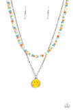 Gliding from a dainty, silver chain, a smiley face pendant stands out against a yellow backdrop. Completing the charismatic ensemble, a collection of seed beads in shades of baby pink, apple green, white, orange, and turquoise create bright pops of color around the neckline for a youthful finish. Features an adjustable clasp closure.