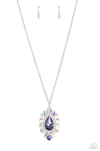 Encircling an oversized, faceted, purple teardrop, an explosion of iridescent marquise-cut gems fans out below the chest reflecting light off every surface. A row of white rhinestones pressed in square silver fittings directly borders the teardrop for additional shimmer. Featured directly below the oversized teardrop, a round rhinestone splashed in the same hue finishes off the glittery design. Features an adjustable clasp closure. Due to its prismatic palette, color may vary.