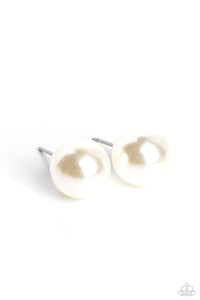 An oversized white pearl, stands out against the ear adding a timeless twist to a basic staple piece perfect for layering. Earring attaches to a standard post fitt