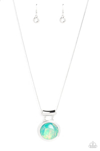 Featuring a refracted shimmer and an opalescent finish, an oversized, glassy blue gem falls along the chest on a silver snake chain to create a hypnotic pop of color. The exaggerated sparkle is pressed into a silver circular frame with a bowing silver frame, bringing a touch of metallic grit to the design. Features an adjustable clasp closure. Due to its prismatic palette, color may v