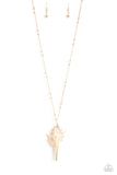 Cascading down the chest from an elongated gold chain sporadically infused with gold studs, a conch shell lined with glittering gold creates a stunning seaside statement. Features an adjustable clasp closur